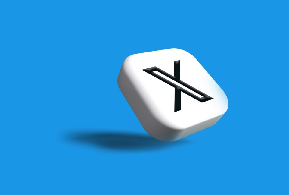 The X icon against a blue gradient